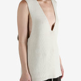 White top worn by a person, showing the top's fit