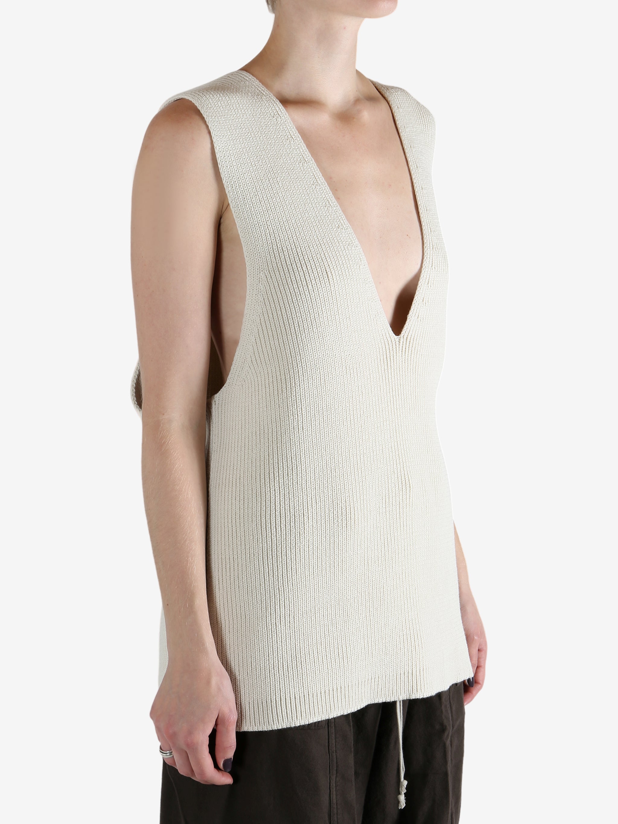 White top worn by a person, showing the top's fit