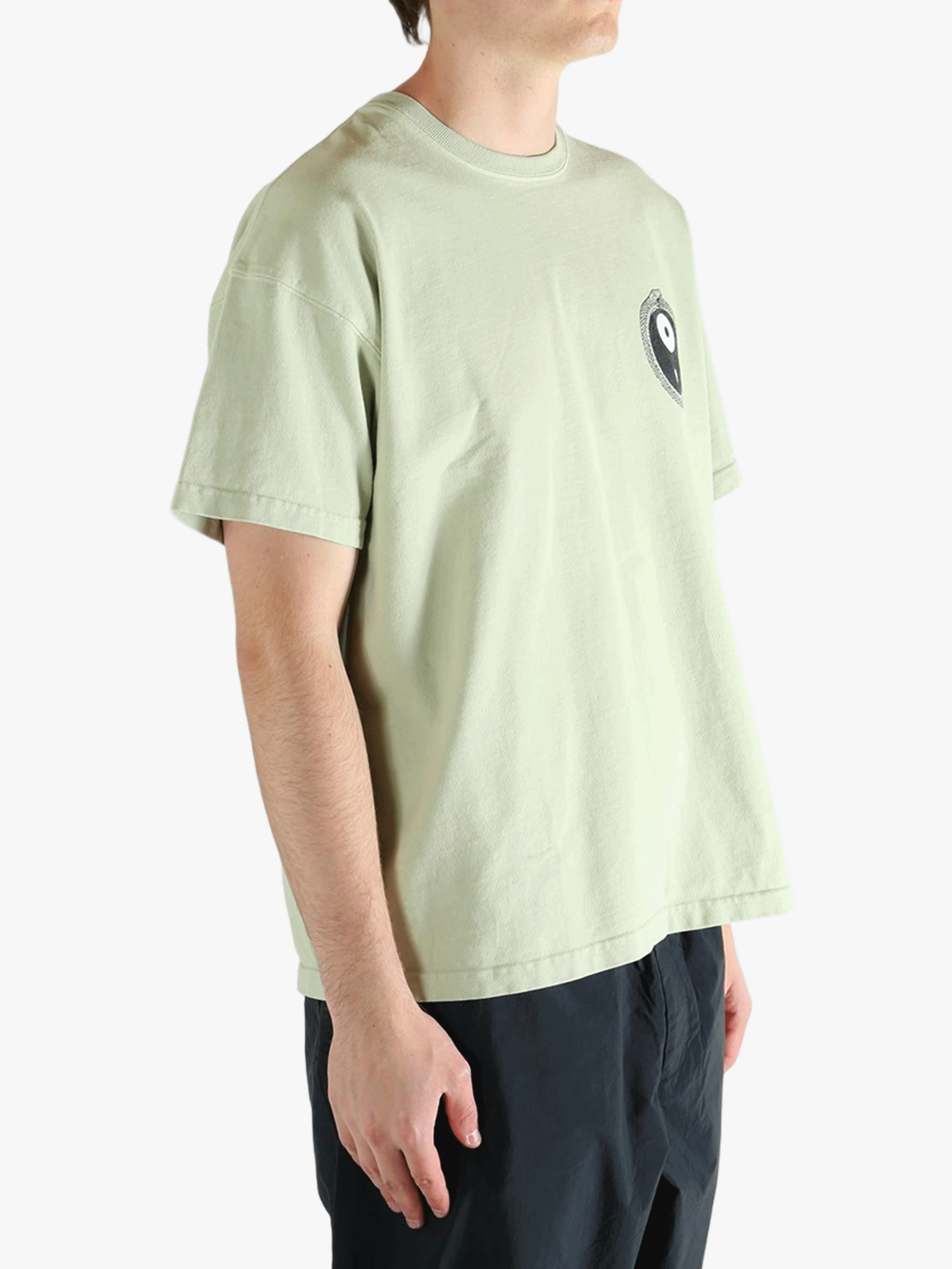 Green t-shirt worn by a person, showing the t-shirt's fit