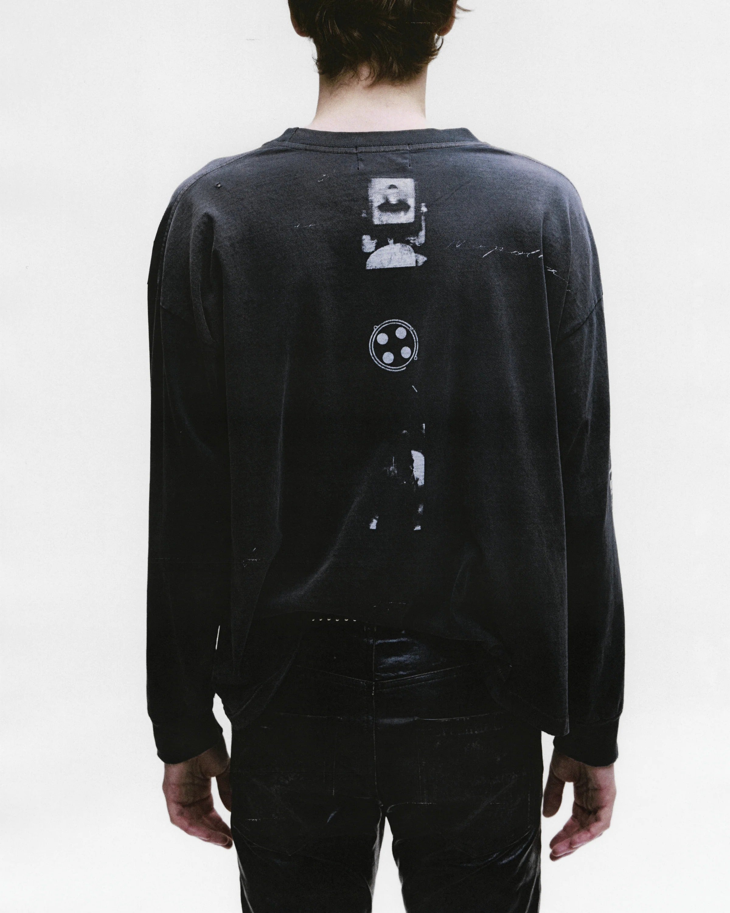 Black t-shirt worn by a person, showing the shirt's fit