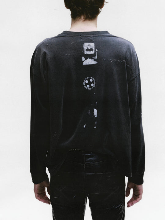 Black t-shirt worn by a person, showing the shirt's fit