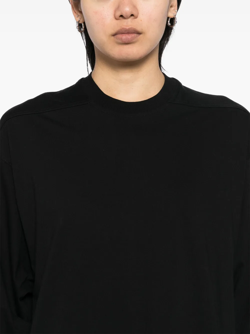 Close up of black t-shirt, showing texture of the cotton fabric.