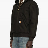 Black jacket worn by a person, showing the jacket fit