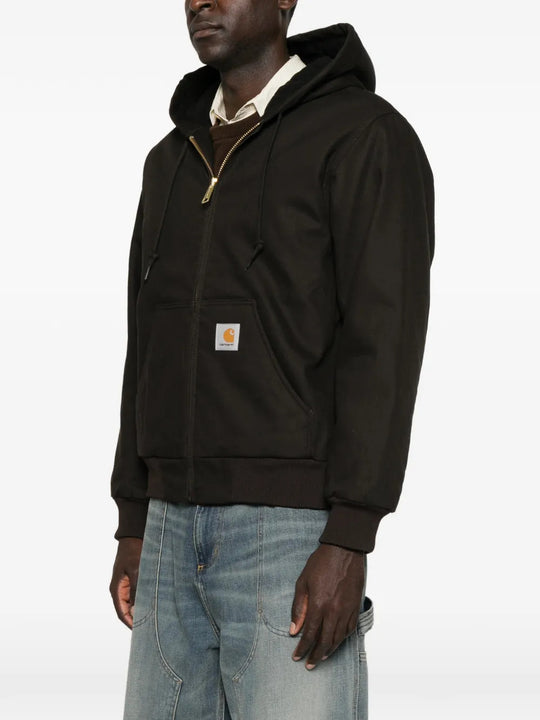 Black jacket worn by a person, showing the jacket fit