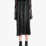 Black coats worn by a person, showing the coat's fit