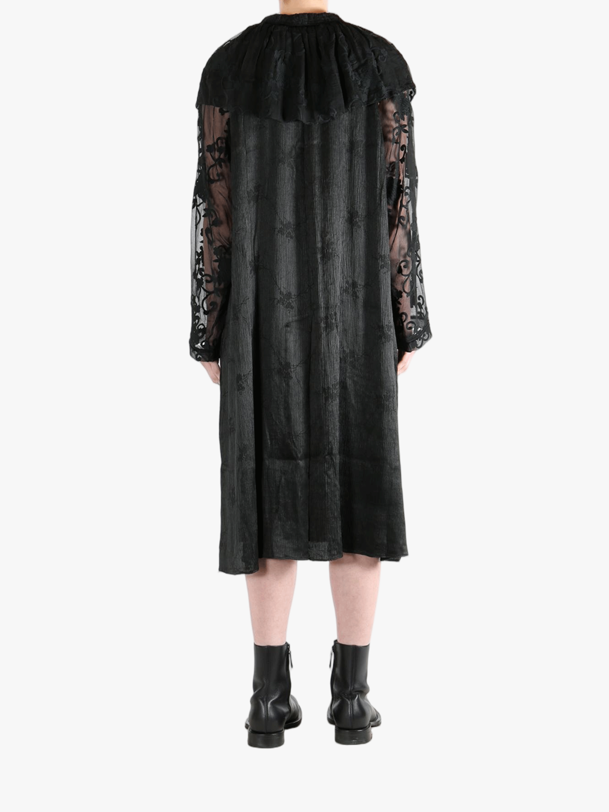 Black coats worn by a person, showing the coat's fit