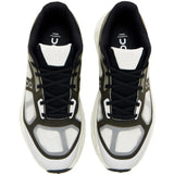 Close up of black sneakers, showing texture of the rubber and polyester fabric