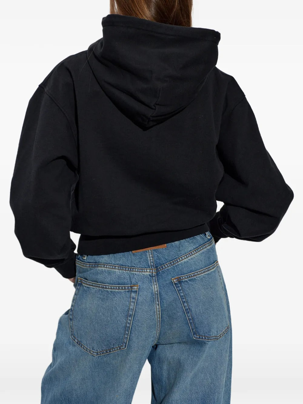 Black hoodie worn by a person, showing the hoodie's fit