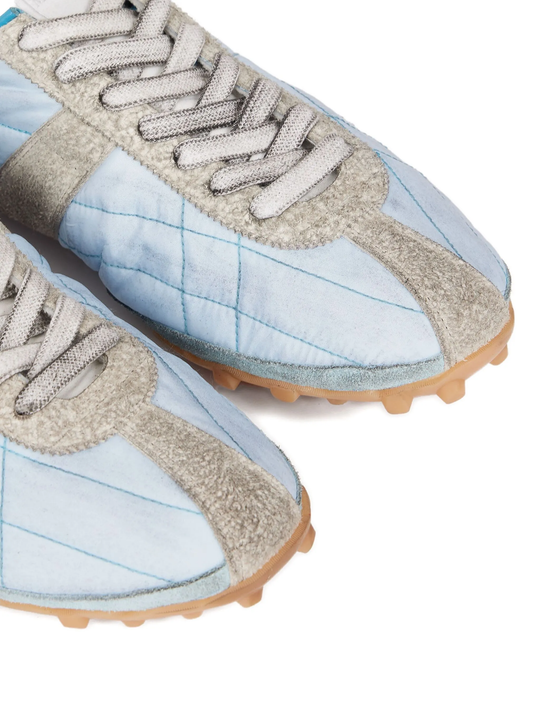 Close up of blue shoes, showing texture of the polyester fabric