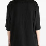 Black t-shirt worn by a person, showing the fit