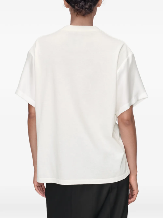 White t-shirt worn by a person, showing the t-shirt's fit
