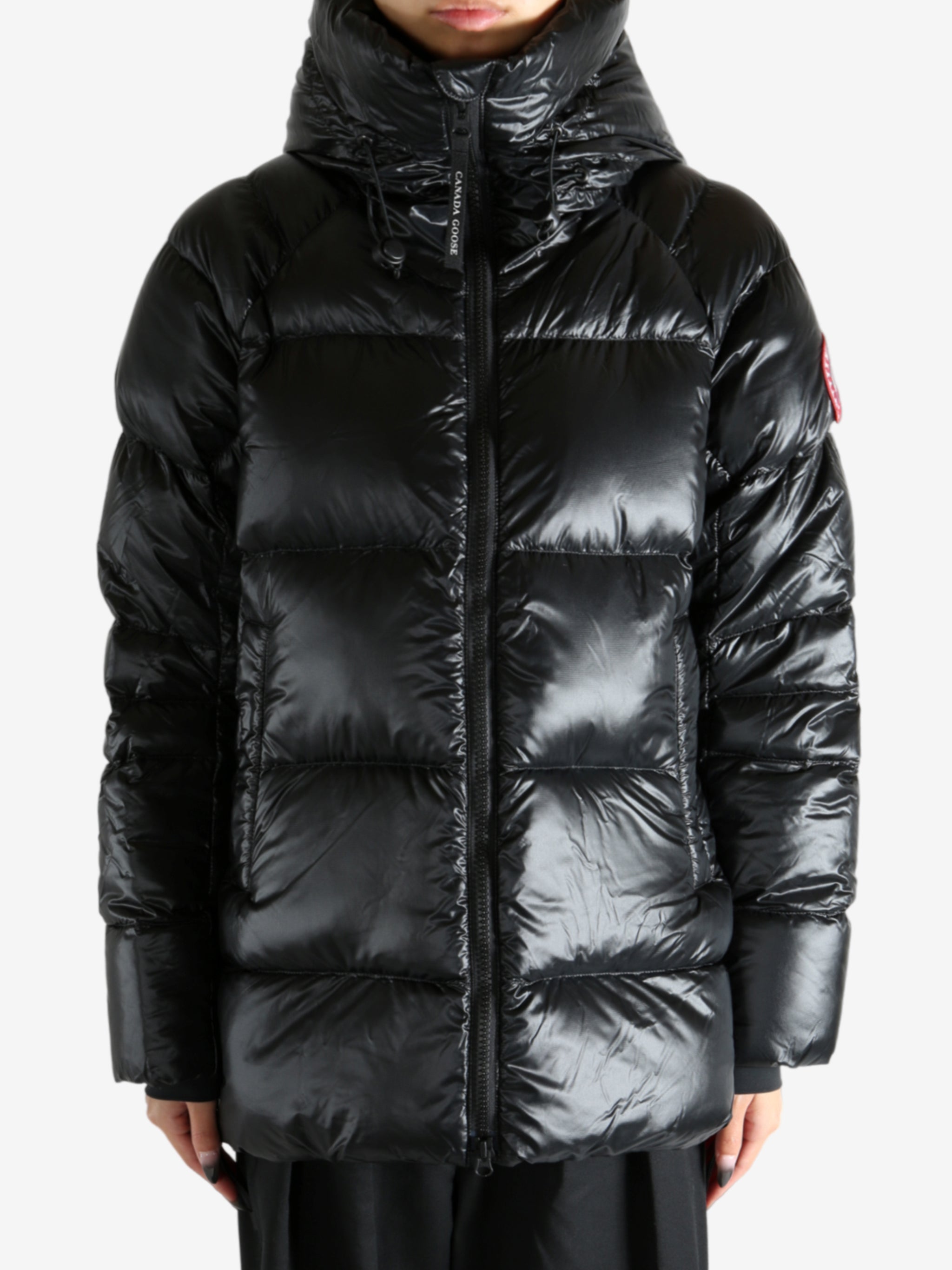 Black coat worn by a person, showing the coat's fit