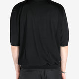 Black T-shirt worn by a person, showing the shirt’s fit