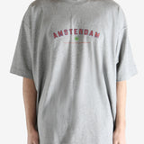 Grey t-shirt worn by a person, showing the t-shirt's fit