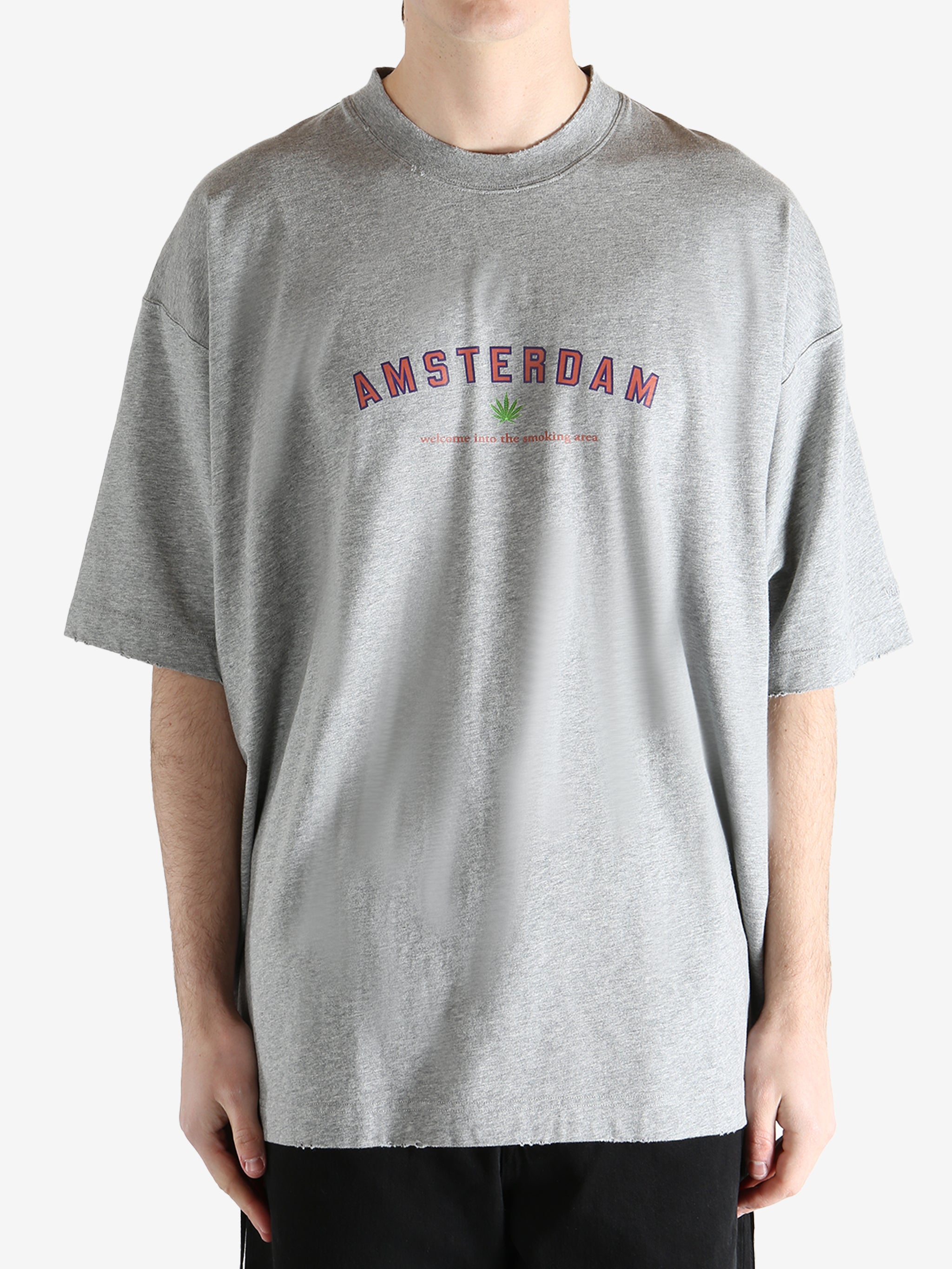 Grey t-shirt worn by a person, showing the t-shirt's fit