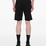 Black shorts warn a person,showing the shorts fit