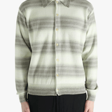 Grey knitwear worn by a person, showing the knitwear's fit