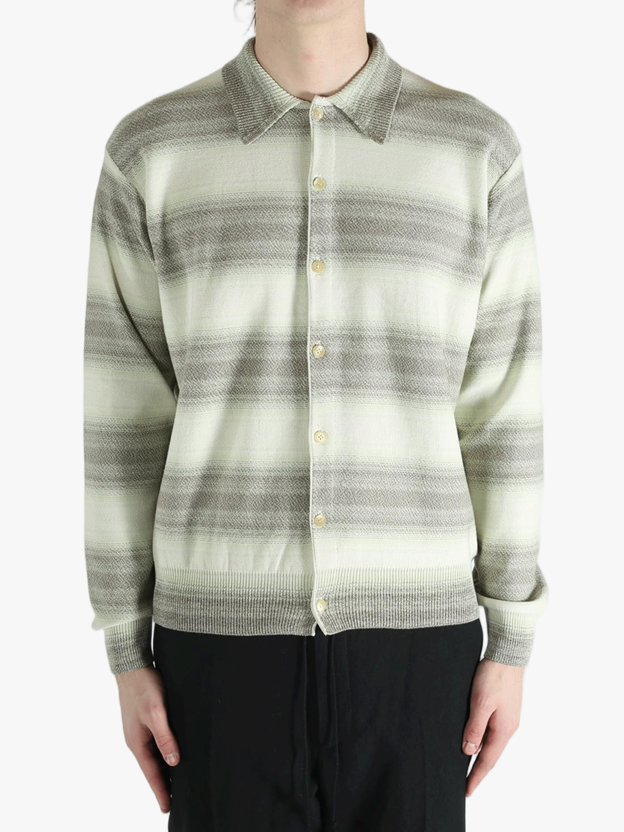 Grey knitwear worn by a person, showing the knitwear's fit