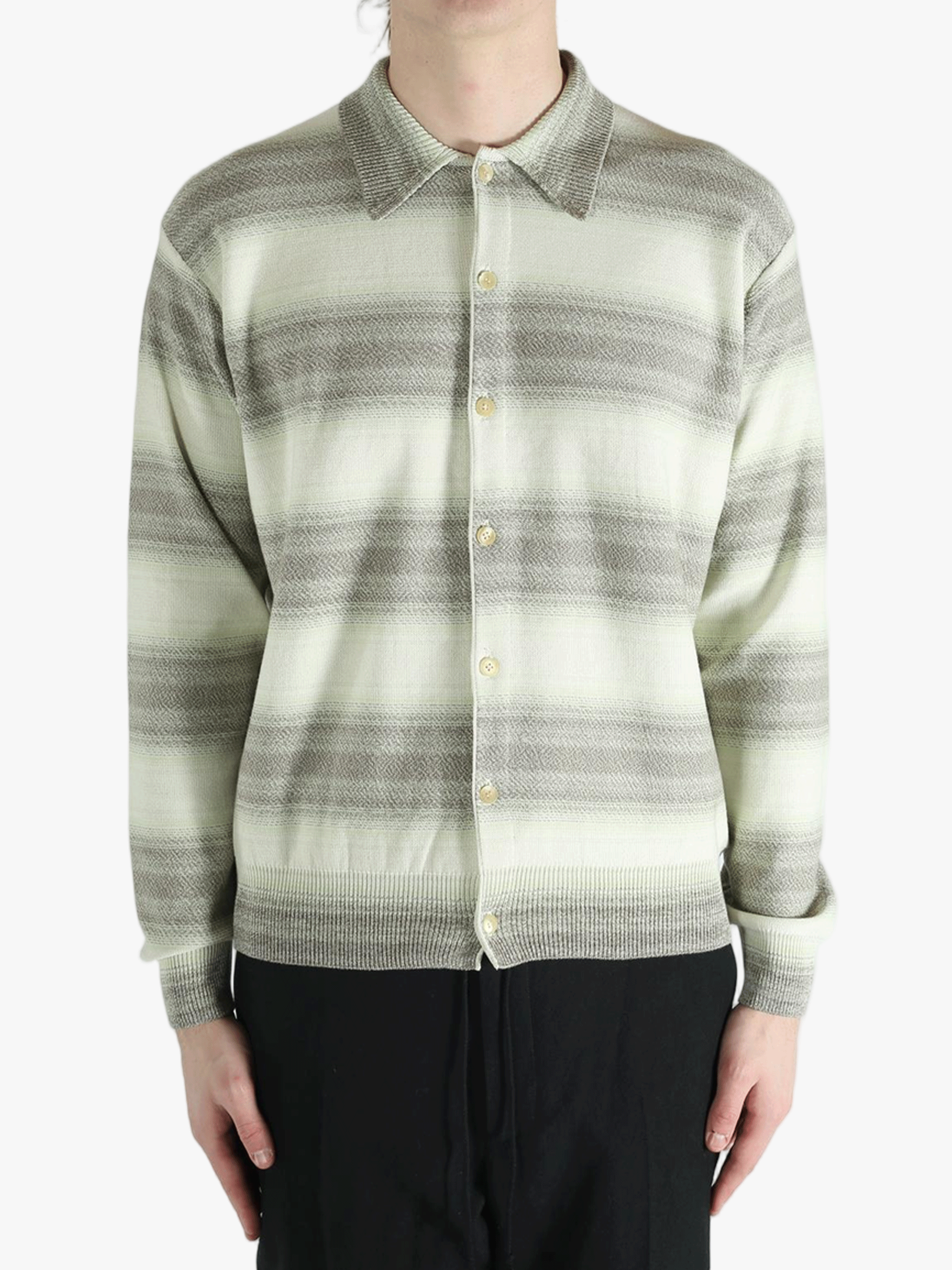 Grey knitwear worn by a person, showing the knitwear's fit