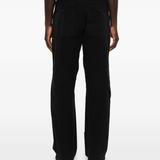 Black pants worn by a person, showing the pants fit