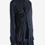 Black top worn by a person, showing the top's fit