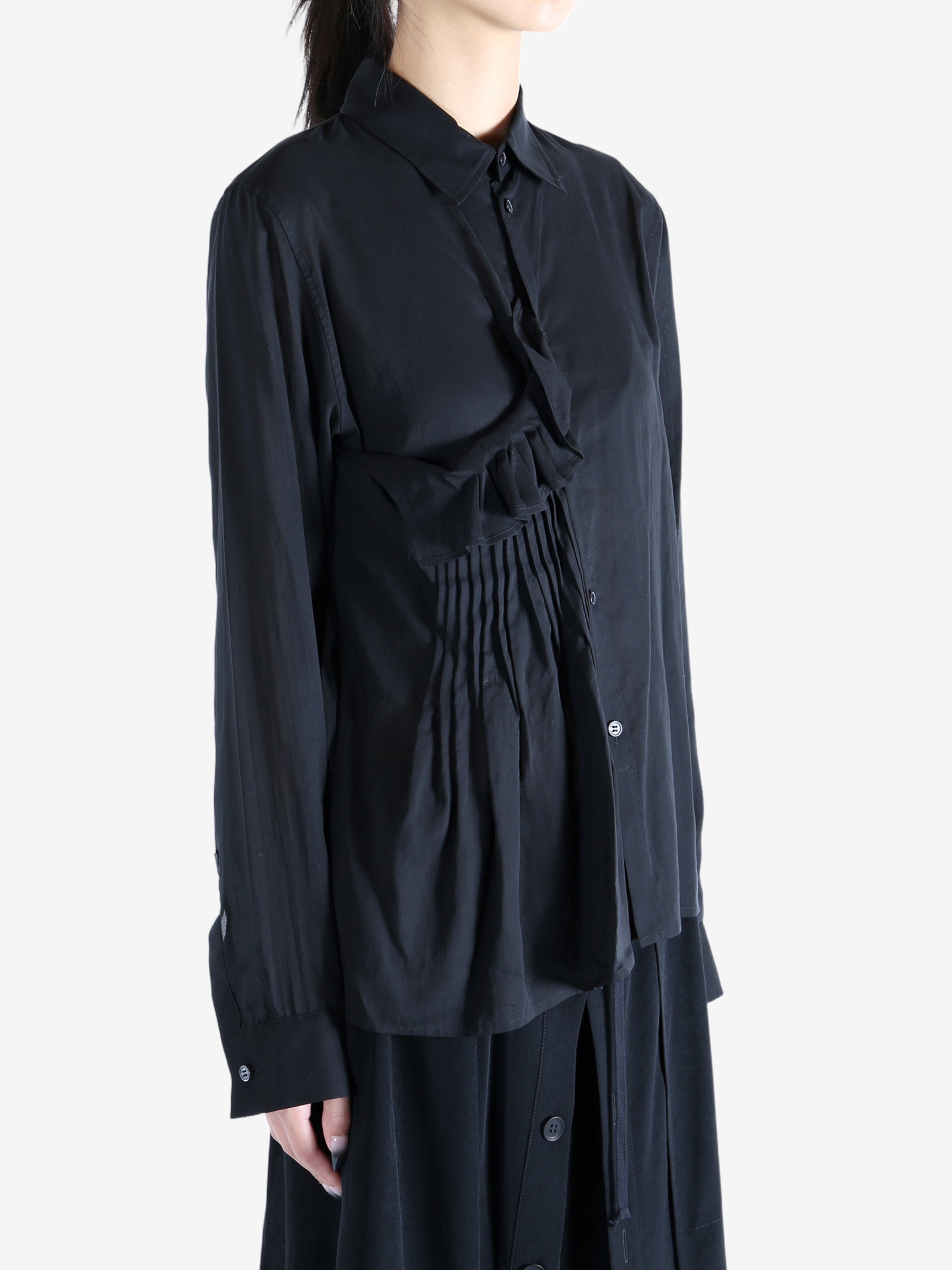 Black top worn by a person, showing the top's fit