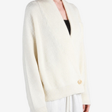 Tan knitwear worn by a person, showing the knitwear fit
