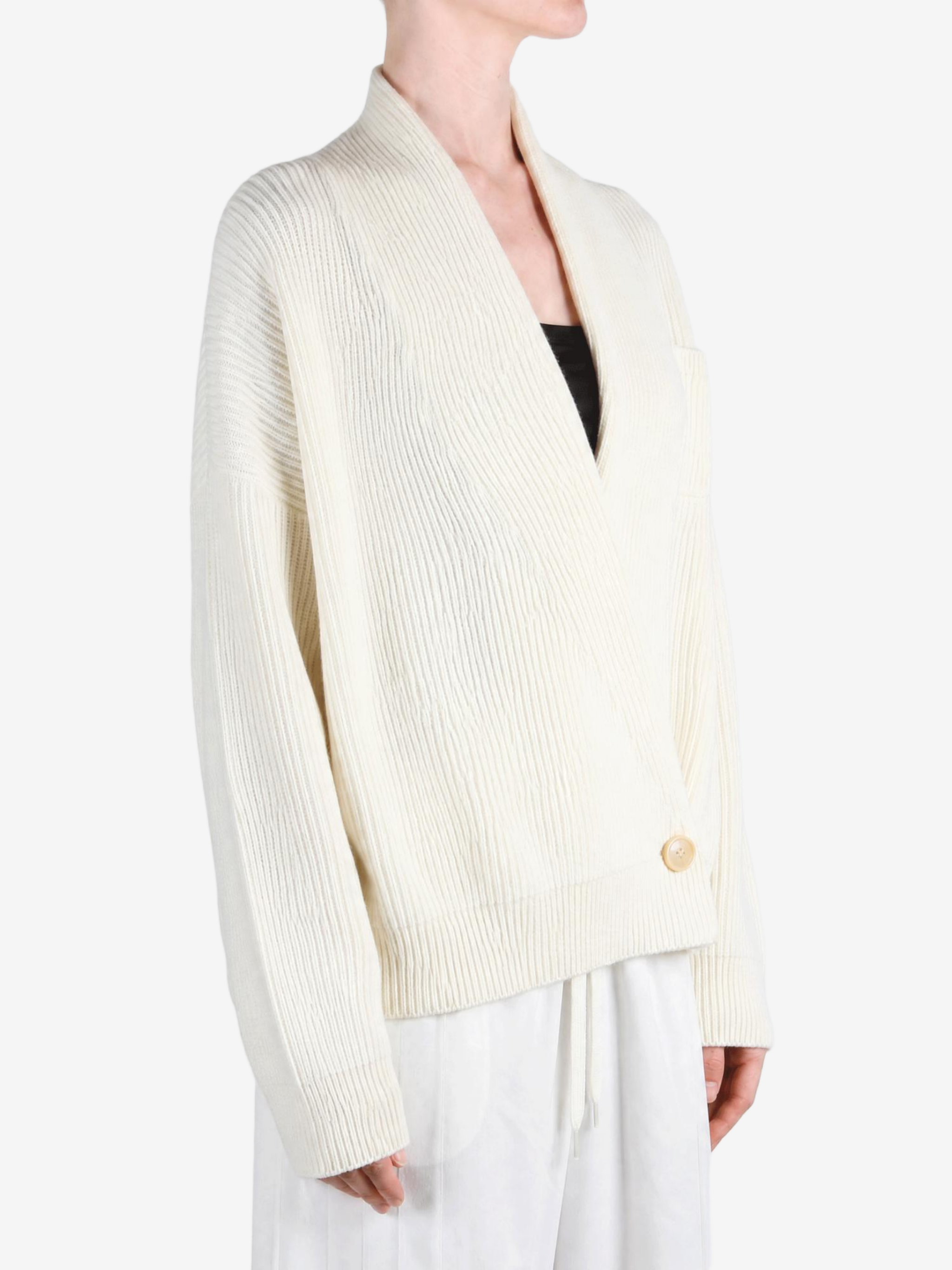 Tan knitwear worn by a person, showing the knitwear fit