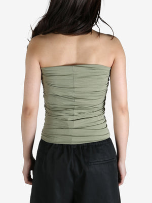 Green top worn by a person, showing the top's fit