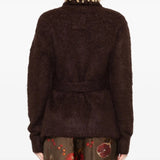 Brown knitwear worn by a person, showing the knitwear's fit