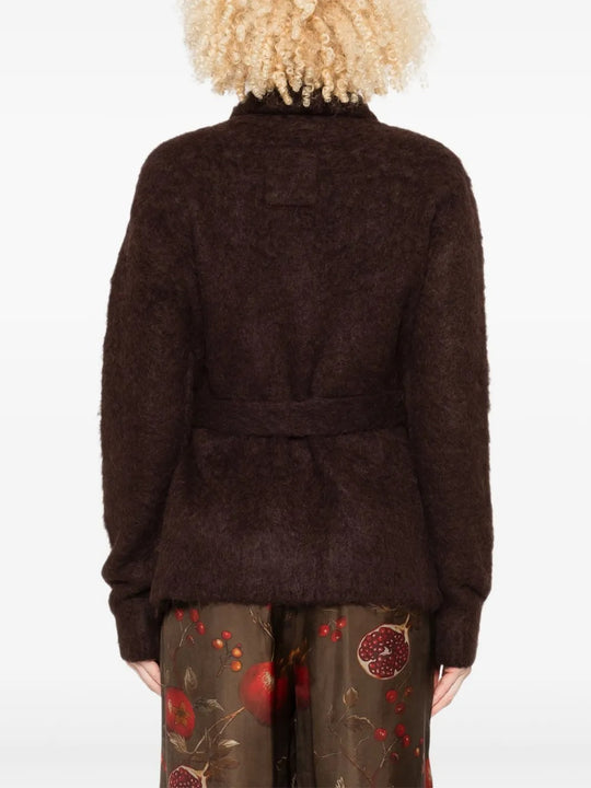 Brown knitwear worn by a person, showing the knitwear's fit