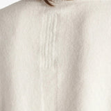 White top worn by a person, showing the top fit