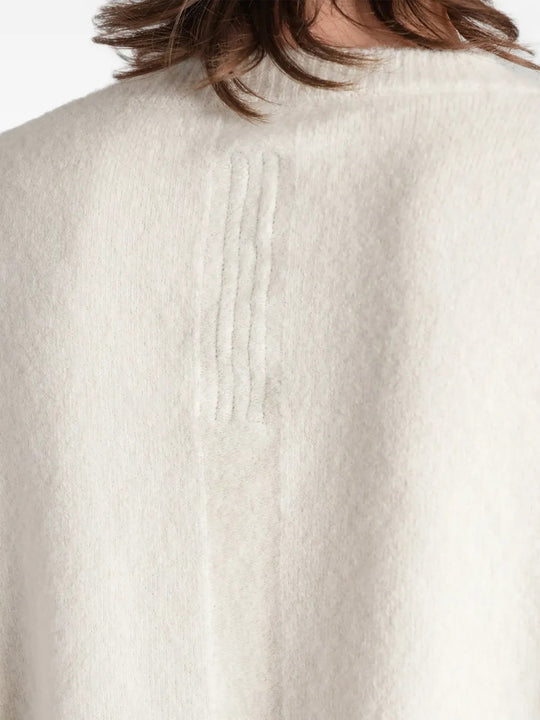 White top worn by a person, showing the top fit