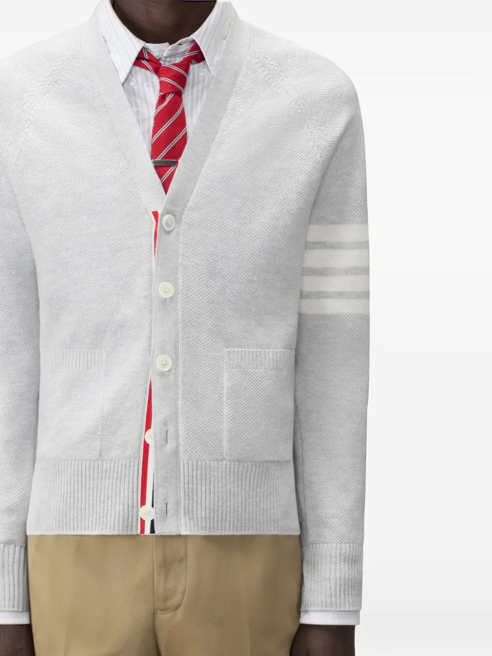 White knitwear worn by a person, showing the knitwear fit