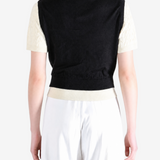 Black shirt worn by a person, showing the shirt fit