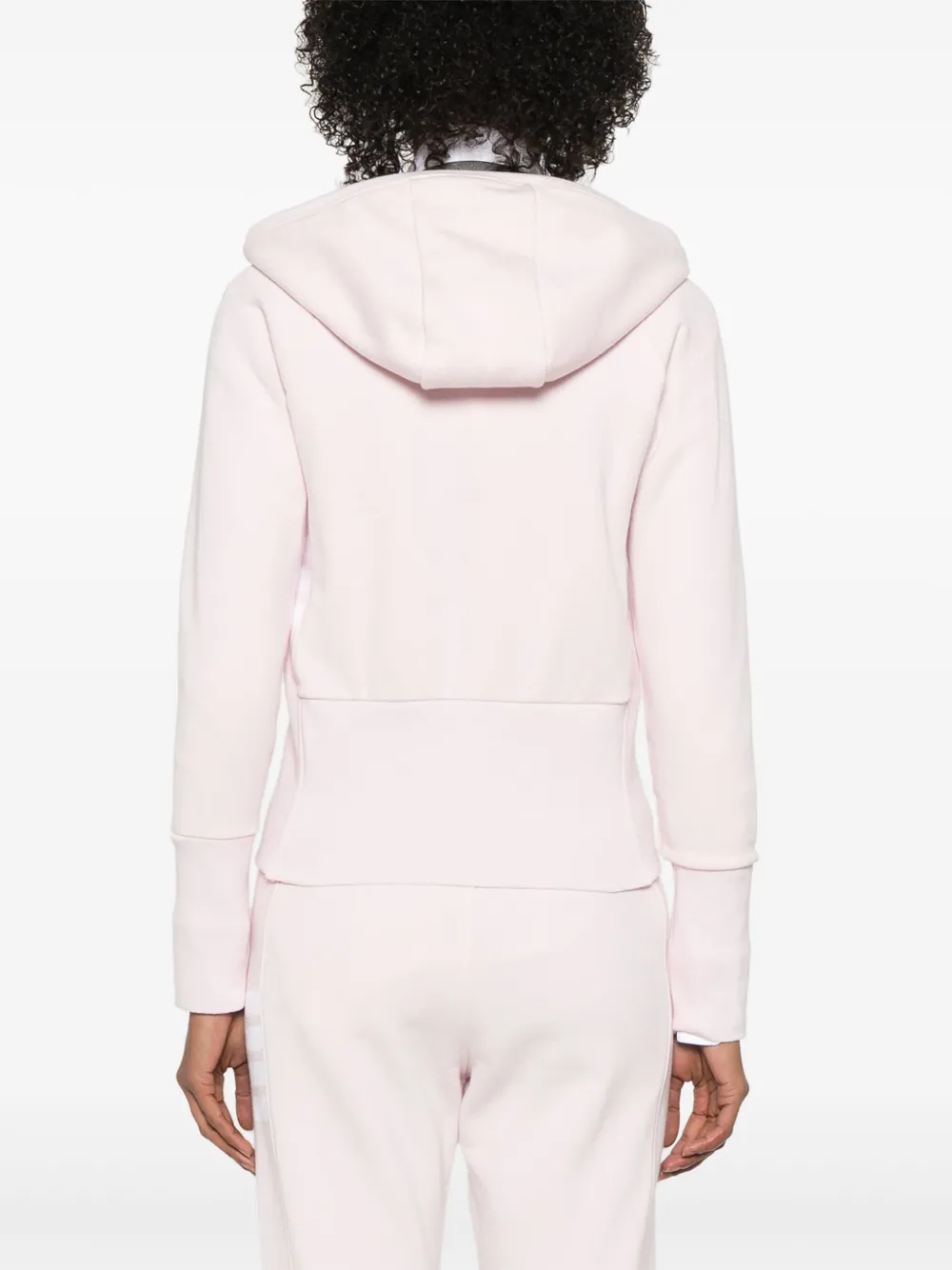 Pink hoodie worn by a person, showing the hoodie's fit