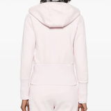 Pink hoodie worn by a person, showing the hoodie's fit