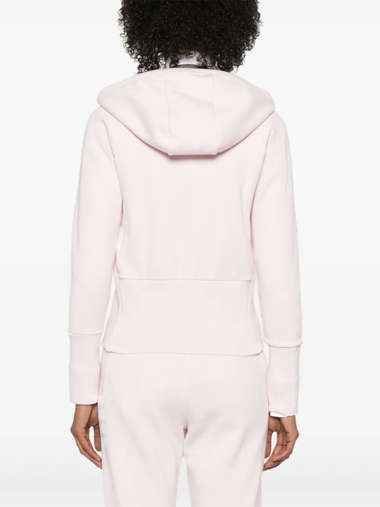 Pink hoodie worn by a person, showing the hoodie's fit