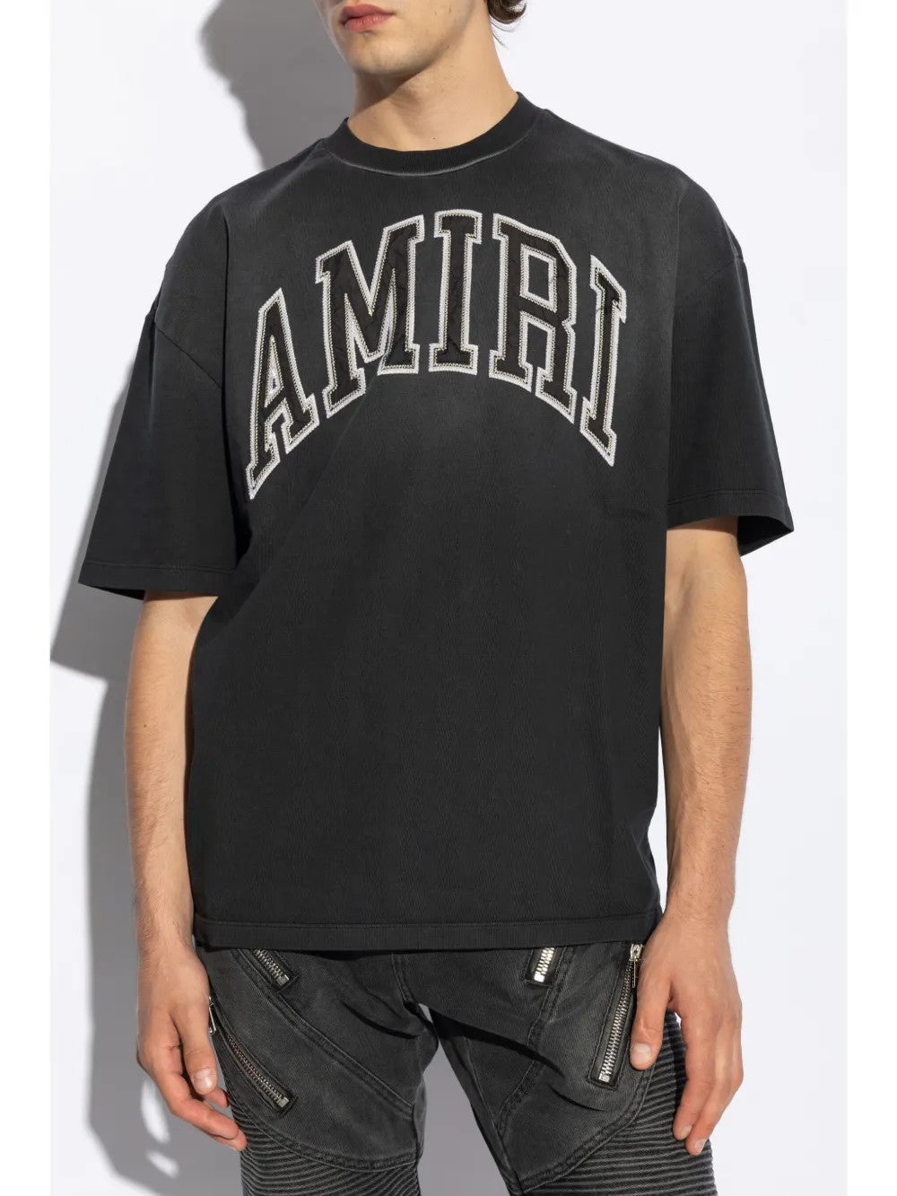 Black t-shirt worn by a person, showing the t-shirt fit