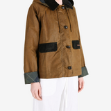 Brown jacket worn by a person, showing the jacket fit