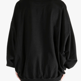 black t-shirts  worn by a person, showing the t-shirts fit