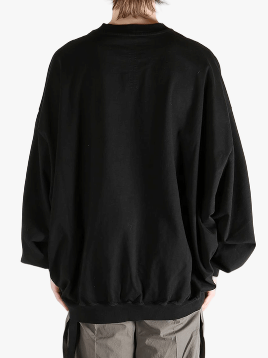 black t-shirts  worn by a person, showing the t-shirts fit