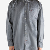 Grey shirt worn by a person, showing the shirt's fit