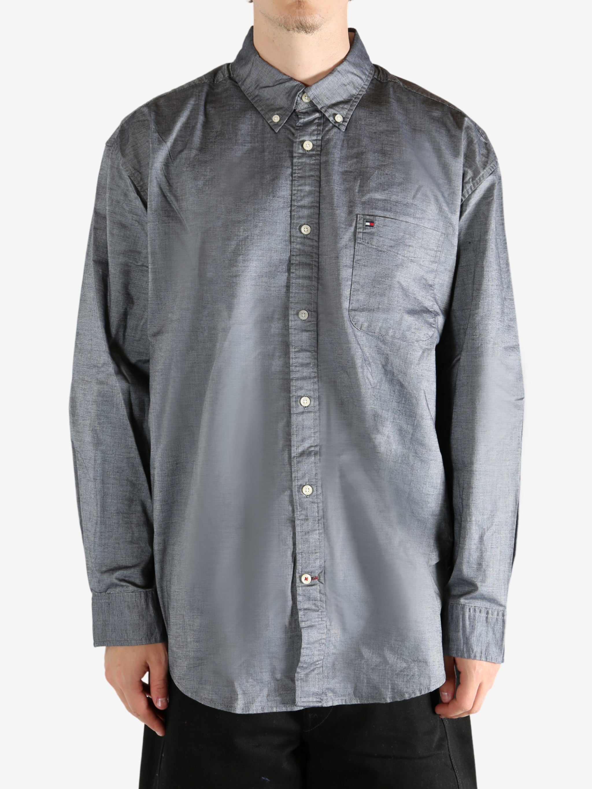 Grey shirt worn by a person, showing the shirt's fit