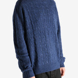 Navy sweater worn by a person, showing the sweater's fit