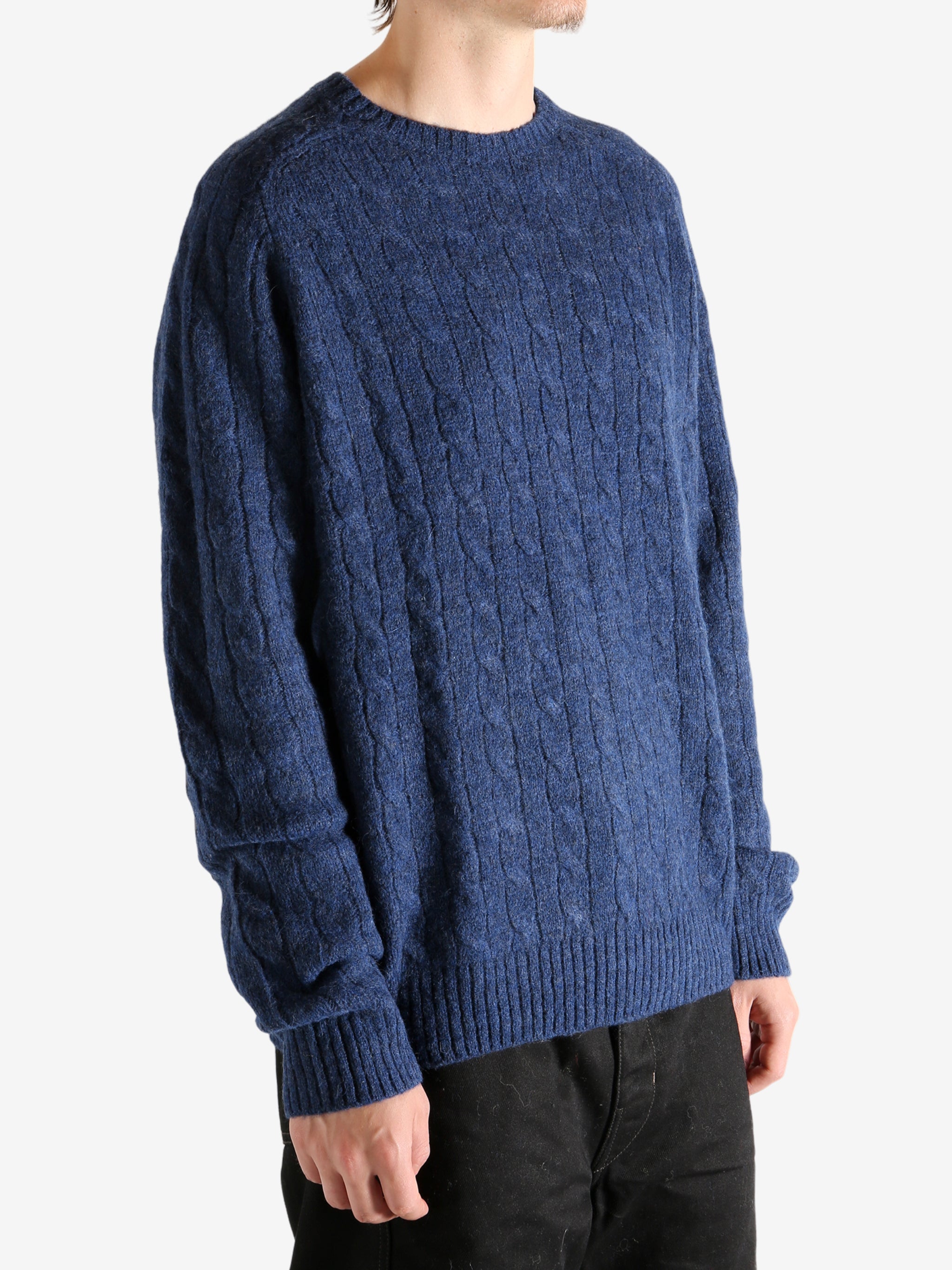 Navy sweater worn by a person, showing the sweater's fit