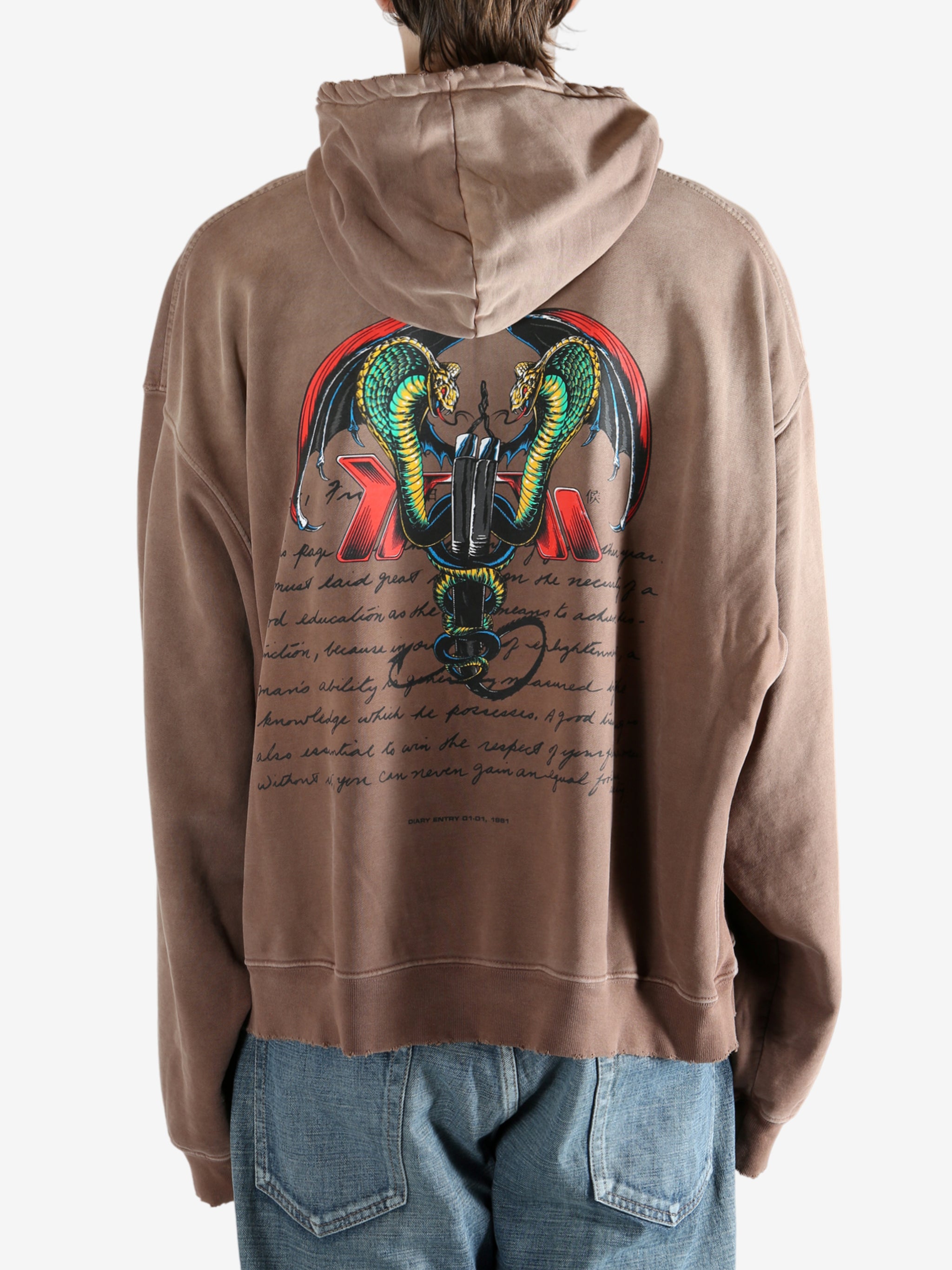 Brown hoodie worn by a person, showing the hoodie's fit