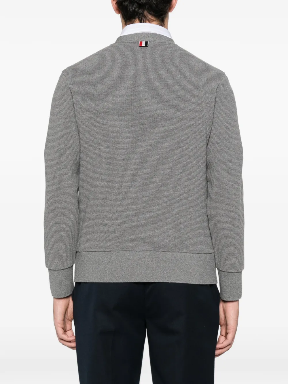 Grey cardigan worn by a person, showing the cardigan fit