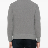 Grey cardigan worn by a person, showing the cardigan fit