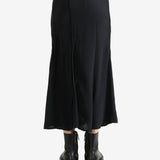 Black skirts worn by a person, showing the skirts fit